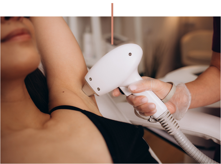 A person receiving underarm laser hair removal treatment in a spa clinic