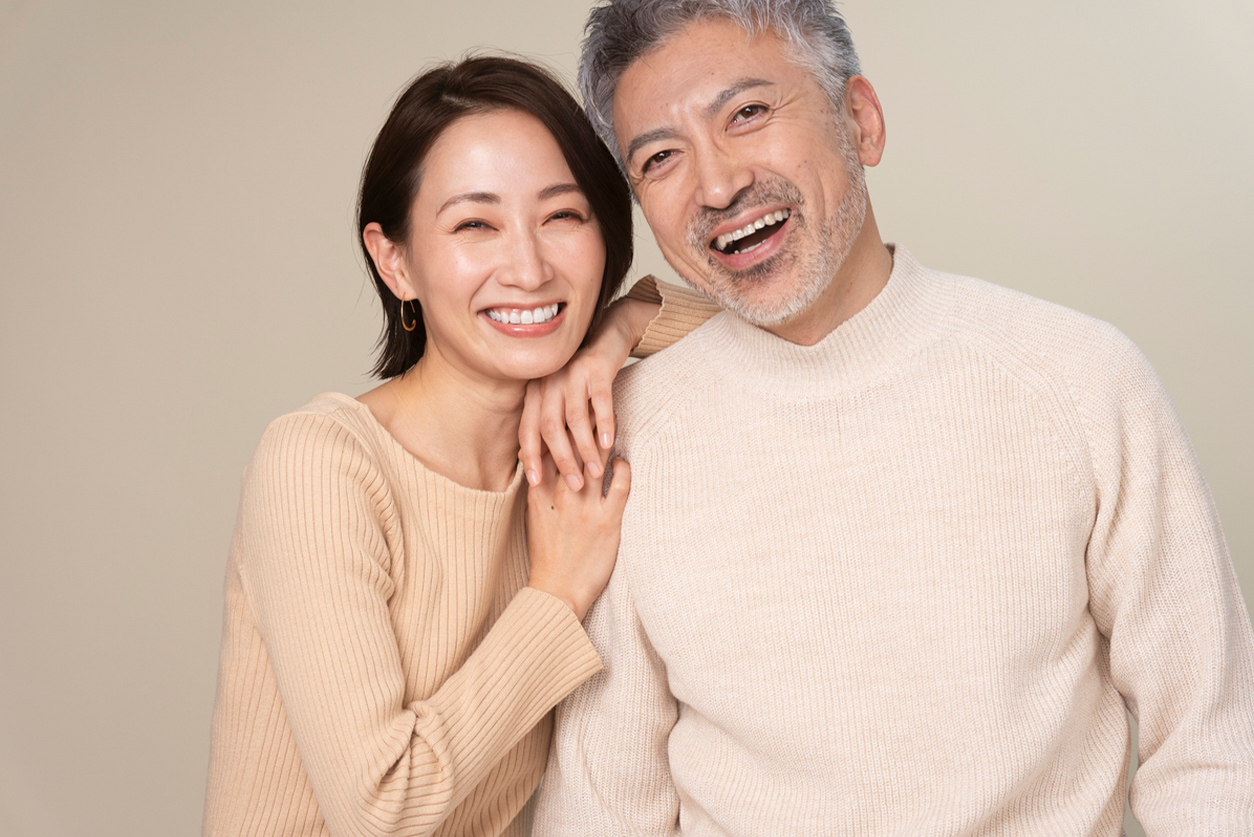 a man and a woman smiling for the camera